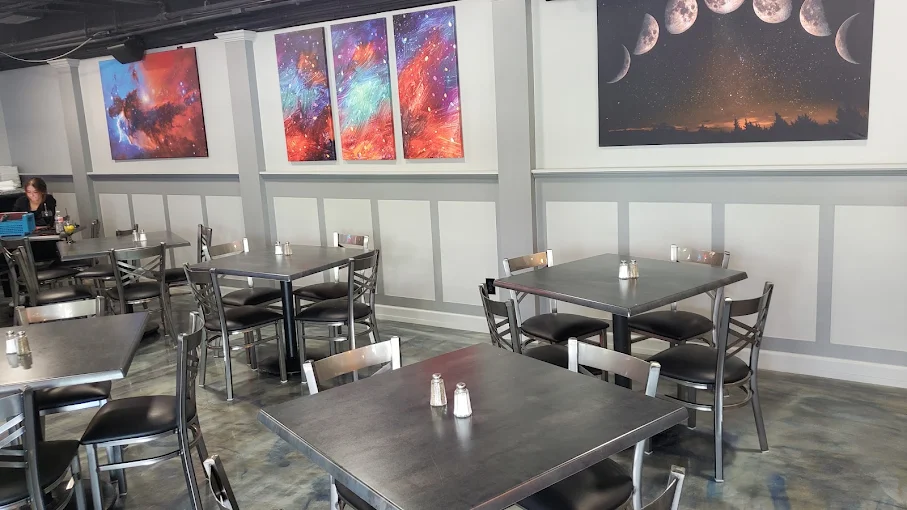 Starlite dining room with cosmic wall art