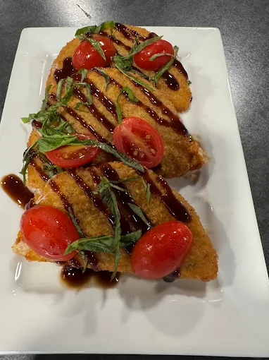 Chicken parmesan with fresh basil and balsamic drizzle