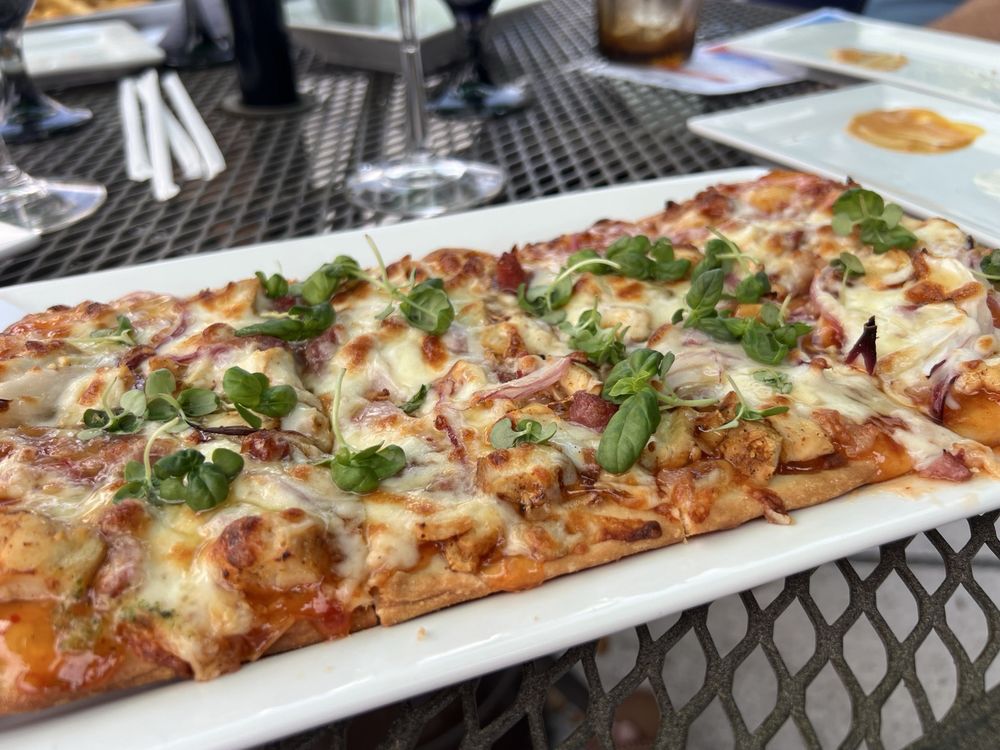 BBQ chicken flatbread with red onion and microgreens